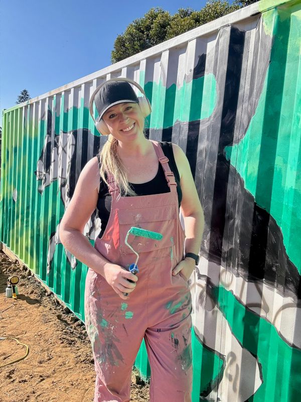 Elizabeth Painting a Mural for a Dog Shelter