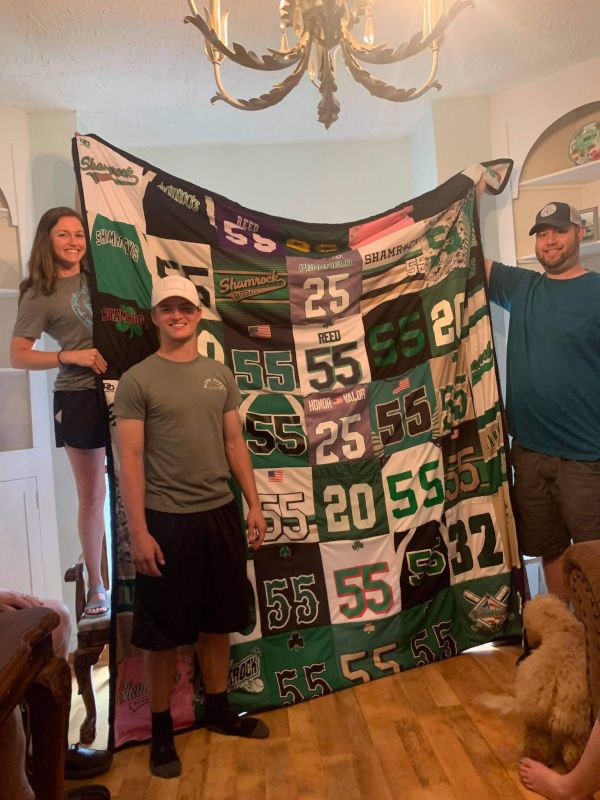 Courtney Giving Her Brother His Jersey Quilt She Made Him for His Graduation